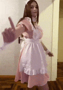 a woman in a maid costume is giving a peace sign