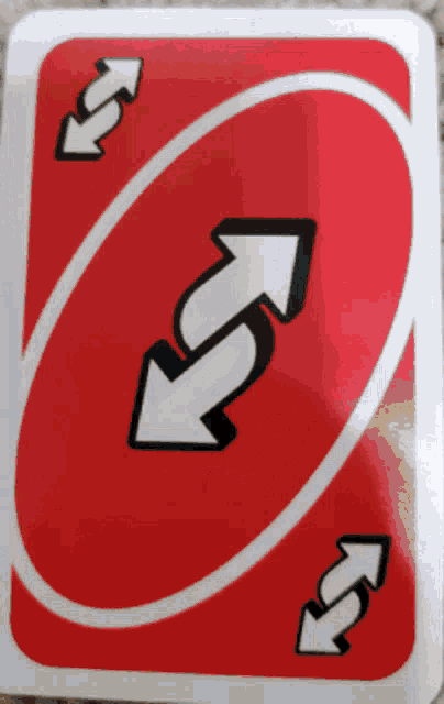 a red uno card with two white arrows pointing to opposite directions
