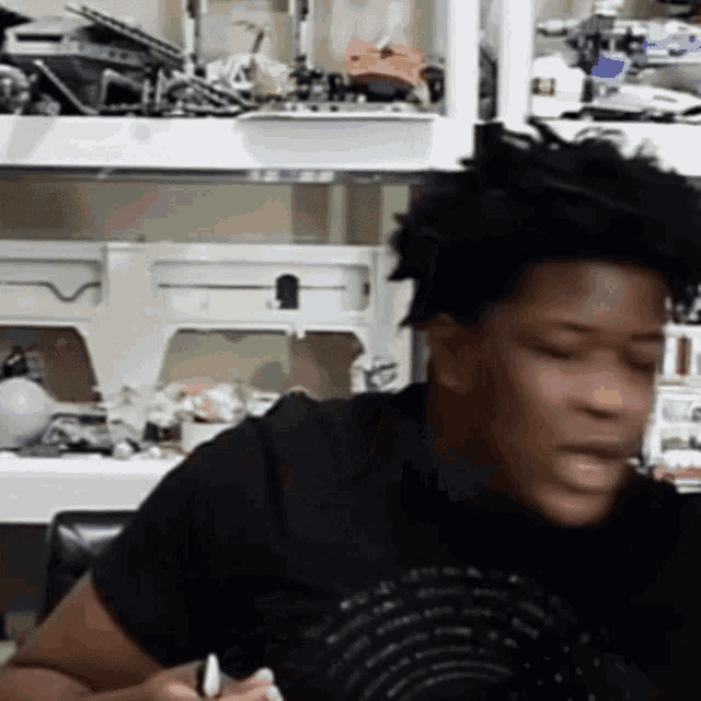 a man sitting in front of a sewing machine