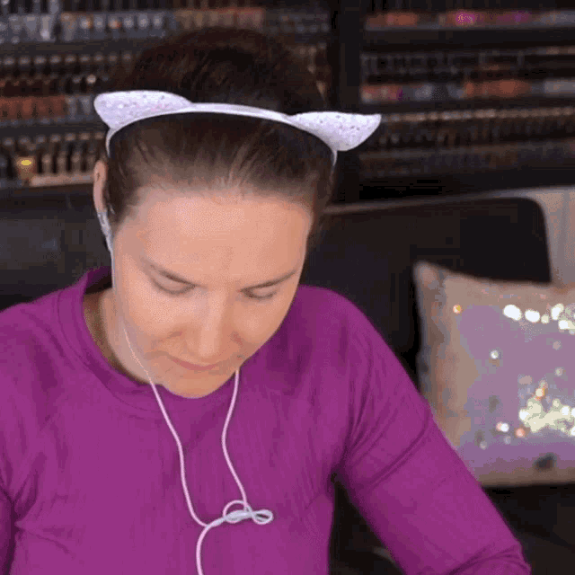 a woman wearing a headband with cat ears on her head