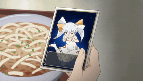 a person is holding a picture of a girl in front of a bowl of soup