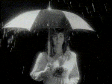 a woman holds an umbrella in the rain