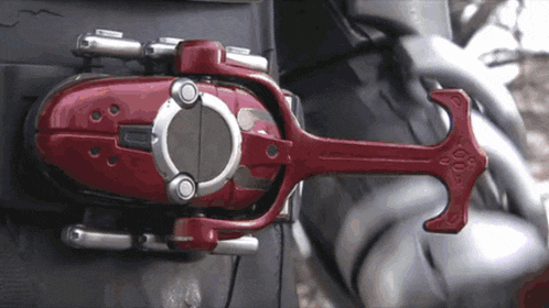 a red object with the letter o on it is attached to a metal object