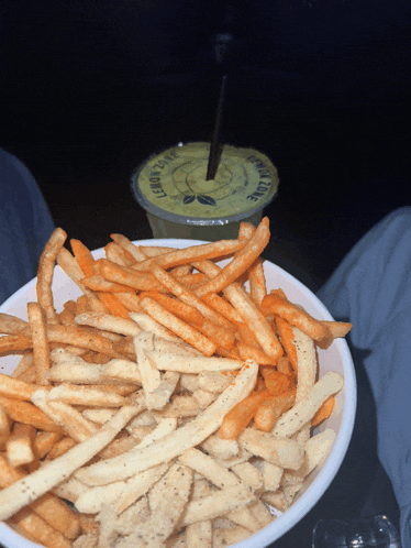 a bowl of french fries next to a drink that says lemon cafe