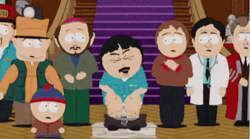 a group of people are standing around a cartoon character sitting on a box .