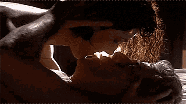 a man and a woman kissing in the dark