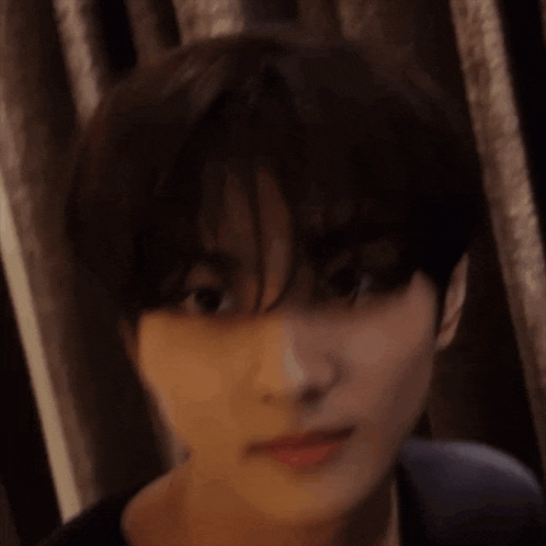 a close up of a person 's face with short hair