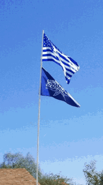 two flags are flying in the wind one of which has the number 52 on it