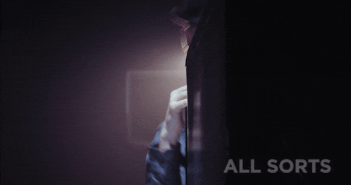 a person standing in a dark room with the words all sorts on the bottom