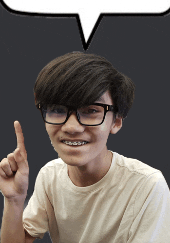 a boy wearing glasses and braces points upwards