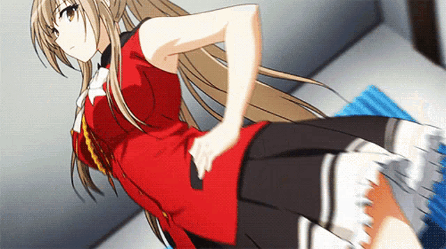 a girl in a red dress is standing on a blue rug