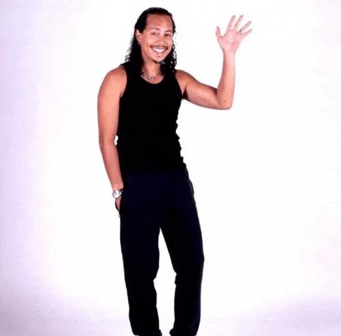 a man in a black tank top and black pants waves his hand