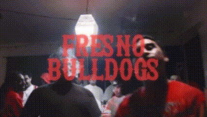 a group of people are gathered in a room with the words fresno bulldogs written in red