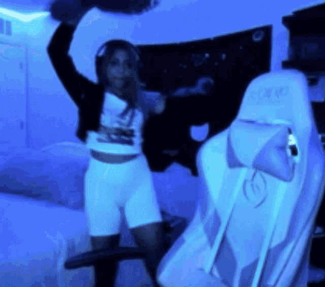 a woman wearing headphones is standing in front of a gaming chair with the word gforce on it