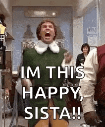 a man in a green elf costume is standing in a room with his mouth open .