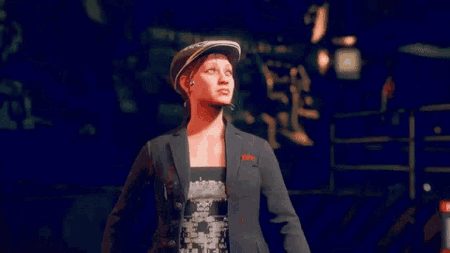 a woman in a suit and hat is standing with her arms wide open