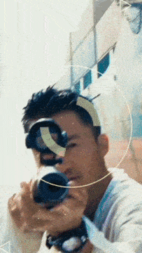 a man taking a picture with a camera with a circle around him