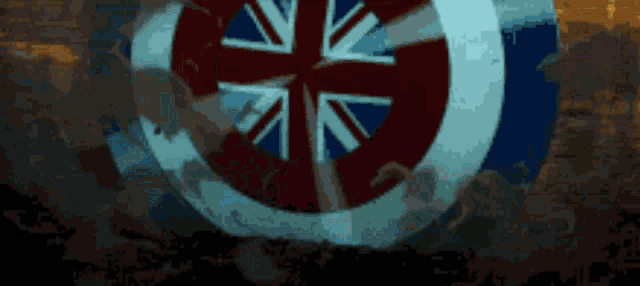 a blue and red circle with a british flag in the center