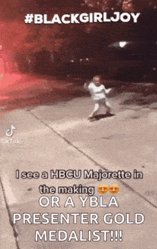 a little girl is dancing on a sidewalk with a caption that says `` black girl joy '' .