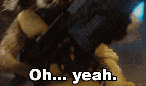 rocket raccoon from guardians of the galaxy is holding a gun and says oh yeah .