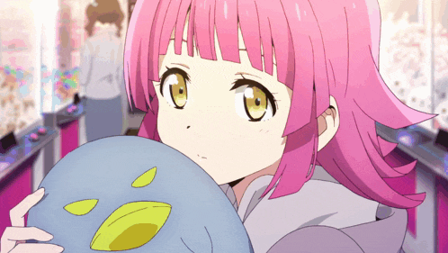 a girl with pink hair and yellow eyes is holding a blue ball
