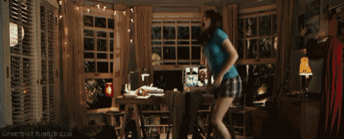 a woman in a blue shirt is dancing in a room with a gif that says gifmethat tumblr.com