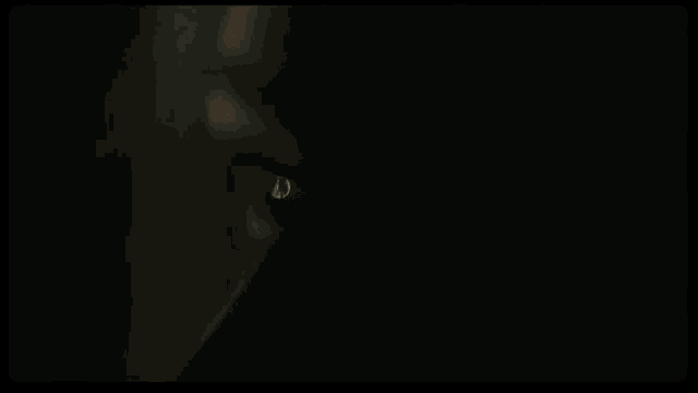 a close up of a woman 's eyes with a tear coming out of her eye