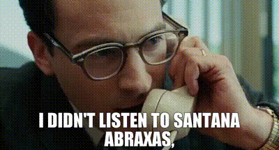 a man wearing glasses is talking on a phone and says i didn 't listen to santana abraxas .