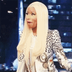 a woman with long blonde hair and a leopard print jacket