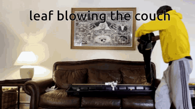 a man in a yellow jacket blows the couch