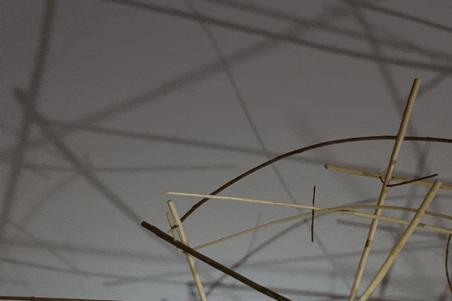 a bunch of sticks hanging from a ceiling