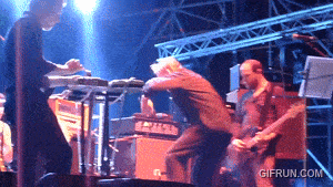 a man playing a keyboard and another man playing a guitar on a stage with gifrun.com in the lower right corner