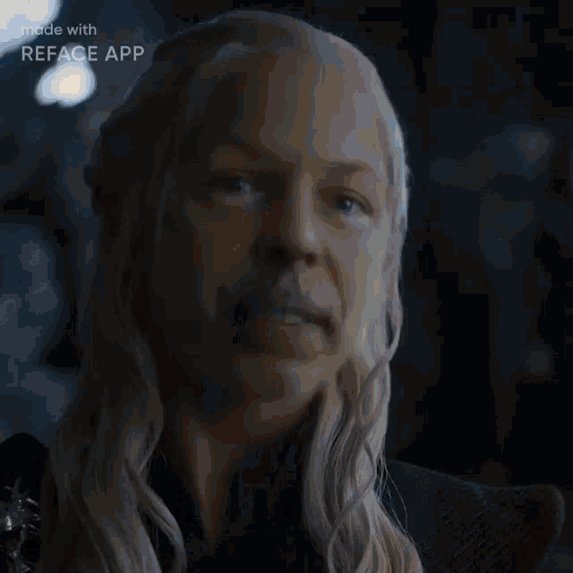 a woman with long blonde hair and a dragon necklace has a face made with reface app
