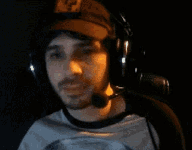 a blurry picture of a man wearing headphones and a baseball cap