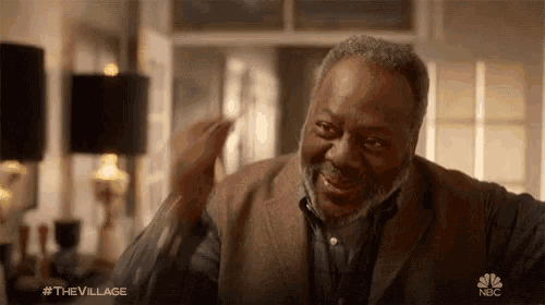 a man with a beard is smiling in a nbc ad for the village