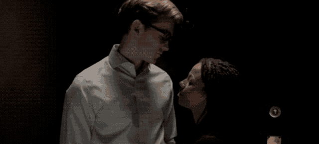 a man and a woman are looking into each other 's eyes .