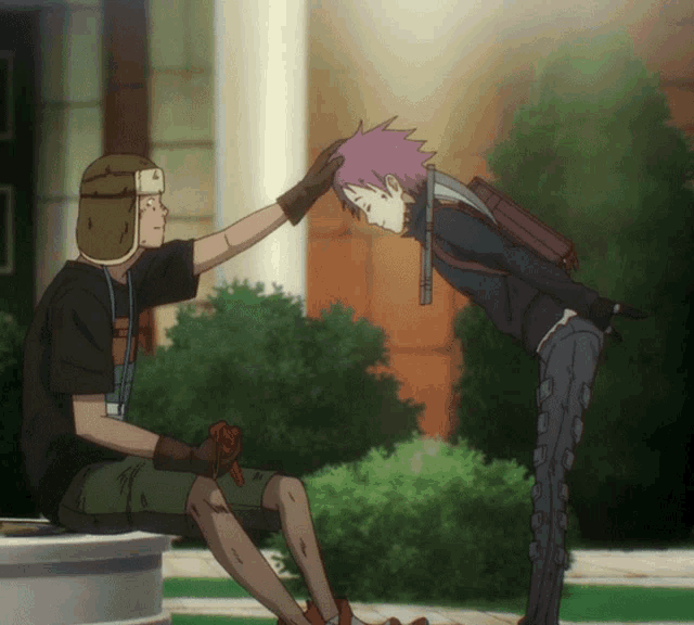 a man in a hat holds another man 's head while they bow to each other