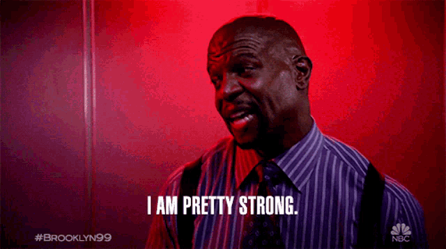 a man says i am pretty strong in front of a red wall