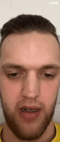 a close up of a man 's face with a beard .