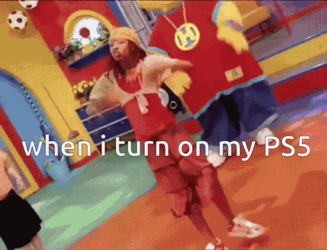a girl in a red shirt is dancing in front of a mascot with the words when i turn on my ps5