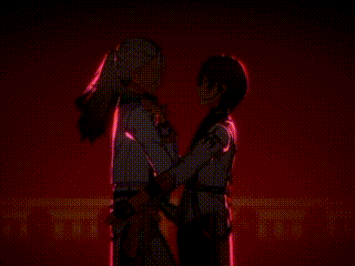 a man and a woman are standing next to each other and looking at each other .