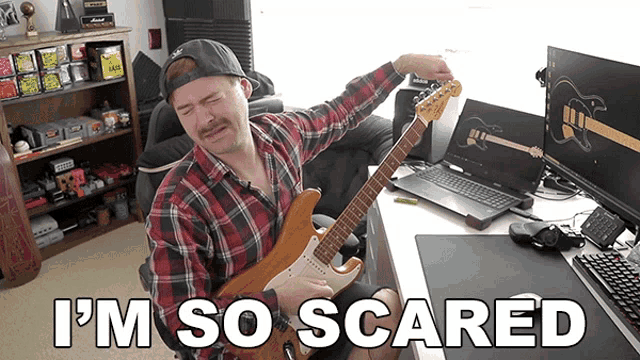 a man playing a guitar with the words i 'm so scared written below him