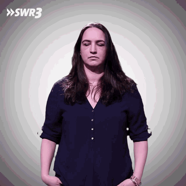 a woman in a blue shirt stands in front of a sign that says swr3 on it