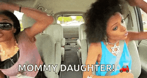 two women are sitting in the back seat of a car with the words mommy daughter above them .
