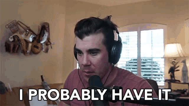 a man wearing headphones says " i probably have it " in front of a microphone