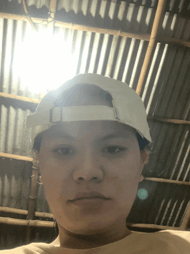 a person wearing a white baseball cap with the letter o on it