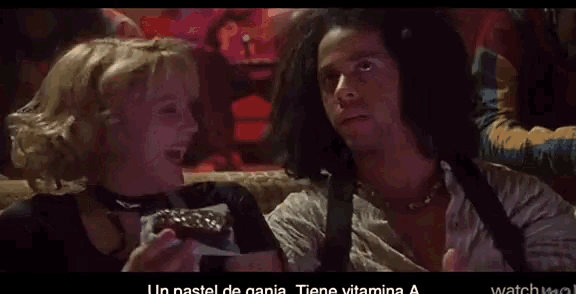 a man and a woman are eating a piece of cake with the words un pastel de ania on the bottom