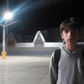 a blurry picture of a boy standing in front of a building