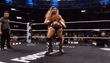 two wrestlers are in a wrestling ring with the word ram on the ground