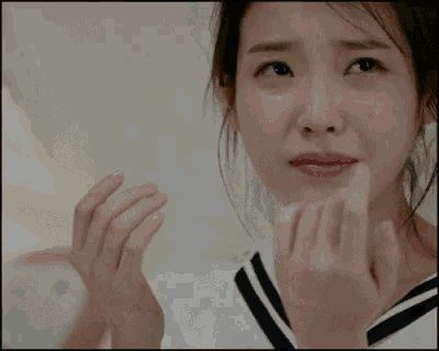 a close up of a woman crying with her eyes closed .
